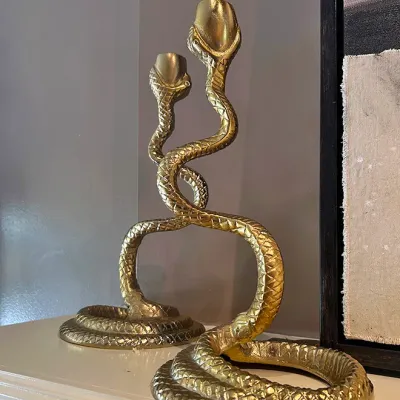 Sale Photo Thumbnail #82: Pair of brass cobra snake candlesticks with coiled bases and textured scale details.