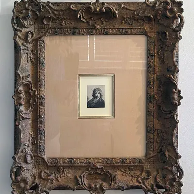 Sale Photo Thumbnail #201: Small framed Rembrandt-style self-portrait etching print, heavily double-matted and housed in an ornate, antique-style gilded gesso picture frame.