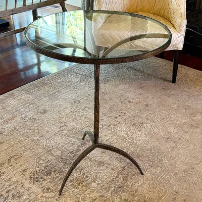 Sale Photo Thumbnail #233: Contemporary round accent table featuring a clear glass top supported by a textured dark bronze forged iron tripod pedestal base.