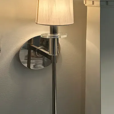 Sale Photo Thumbnail #195: Modern brushed nickel wall sconce with a long slim tail, clear acrylic accent ring, and an off-white pleated fabric shade.
