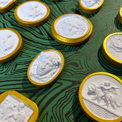 Sale Photo Thumbnail #18: Collection of Neoclassical plaster intaglio cameo impressions set in gilt frames, depicting classical figures and mythological scenes.