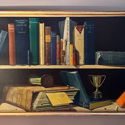 Sale Photo Thumbnail #61: Framed trompe l'oeil bookshelf painting depicting books, trinkets, and a miniature trophy, housed in a thin wooden frame.