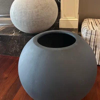 Sale Photo Thumbnail #84: Pair of modern spherical floor planters in contrasting dark gray and light stone finishes.