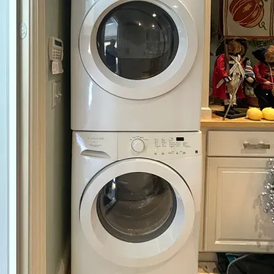 Sale Photo Thumbnail #95: Stacked Frigidaire Affinity front-load washer and dryer set in white finish.