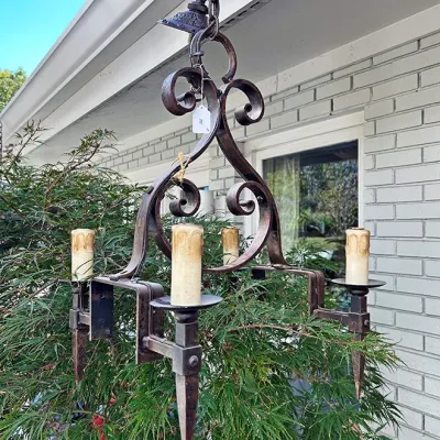 Sale Photo Thumbnail #295: Vintage wrought iron four-light chandelier featuring scrollwork design and faux candle sleeves.
