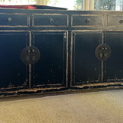 Sale Photo Thumbnail #140: Black distressed Chinese Asian-style sideboard cabinet featuring four drawers and four cabinet doors with traditional round metal hardware.
