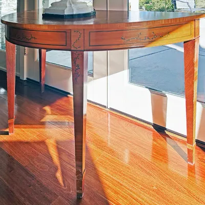 Sale Photo Thumbnail #77: Hepplewhite-style demilune console table featuring inlaid floral and ribbon details along the apron and tapered legs.