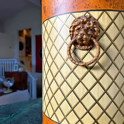 Sale Photo Thumbnail #260: Vintage metal wastebasket or canister featuring a harlequin lattice pattern, floral borders, and a brass lion's head ring handle.