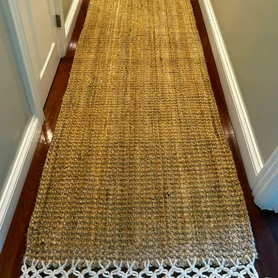 Sale Photo Thumbnail #238: Long woven natural jute hallway runner rug featuring knotted white fringe trim on both ends.