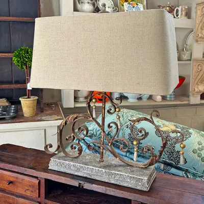 Sale Photo Thumbnail #291: French Country-style wrought iron table lamp with gilt distress finish, hanging beads, molded base, and wide linen shade.