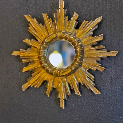 Sale Photo Thumbnail #6: Vintage small sunburst accent mirror featuring a gilded, textured frame with a starburst pattern.