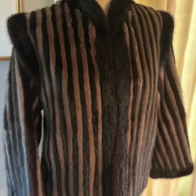 Sale Photo Thumbnail #165: Vintage striped mink fur jacket with dark brown and taupe panels, featuring a plush collar and structured shoulders.