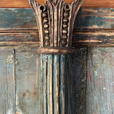 Sale Photo Thumbnail #272: Antique carved wooden column detail featuring an ornate capital with beadwork and fluted shaft, finished in distressed paint tones.