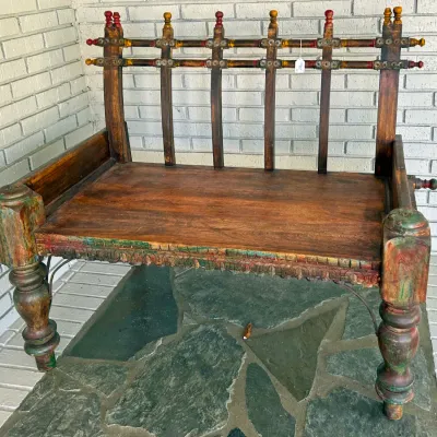 Sale Photo Thumbnail #290: Rustic Indian or Damchiya style wooden bench featuring hand-carved detailing, turned legs, painted accents, and a spindle-grate backrest.