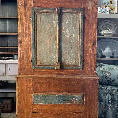Sale Photo Thumbnail #270: Rustic antique wooden armoire cabinet featuring distressed blue-green painted panels and a central carved column detail.
