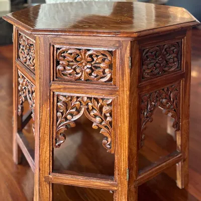 Sale Photo Thumbnail #79: Anglo-Indian carved hardwood octagonal side table featuring intricate floral fretwork panels and arched apron detailing.