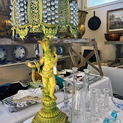 Sale Photo Thumbnail #287: Ornate Hollywood Regency style cherub table lamp with a green patinated metal finish and a crystal-beaded shade.