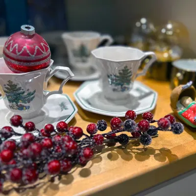 Sale Photo Thumbnail #88: Collection of Christmas decorations including vintage Spode Christmas Tree teacups and saucers, frosted berry sprigs, and a red ornament.