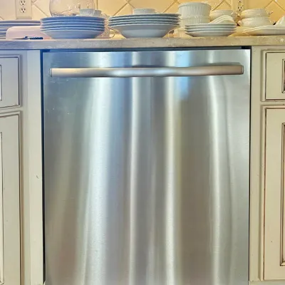 Sale Photo Thumbnail #46: Modern stainless steel built-in dishwasher installed under a kitchen countertop.