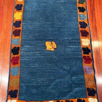 Sale Photo Thumbnail #53: Hand-knotted Gabbeh wool area rug featuring a central leaf motif on a teal field with a multi-colored leaf border.