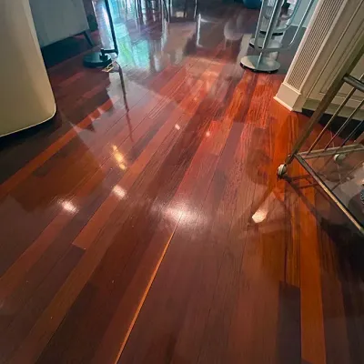 Sale Photo Thumbnail #96: Polished Brazilian cherry hardwood flooring throughout a home interior, featuring a high-gloss finish and varied reddish-brown tones.