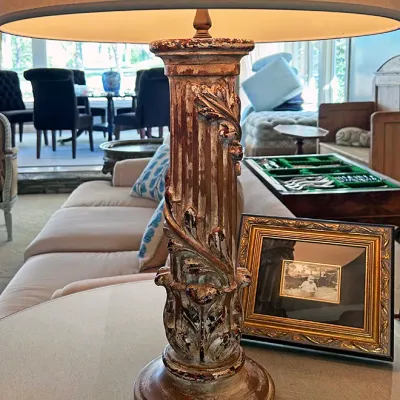 Sale Photo Thumbnail #127: Vintage table lamp featuring a distressed, ornate column-style carved base and a beige drum shade.