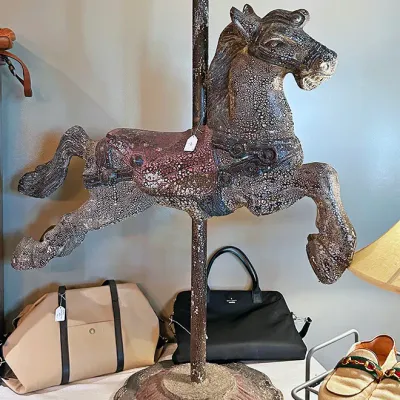 Sale Photo Thumbnail #292: Vintage painted carousel horse mounted on a metal pole and decorative base, displaying a heavily crackled distress finish.