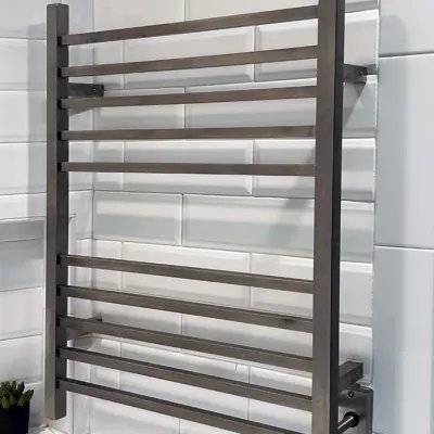 Sale Photo Thumbnail #175: Modern brushed stainless steel wall-mounted heated towel rack mounted on a white subway tile wall.