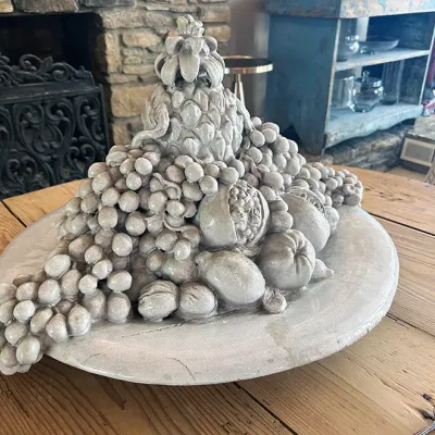 Sale Photo Thumbnail #109: Large Italian-style glazed ceramic fruit centerpiece featuring stacked grapes, lemons, pomegranates, and a pineapple on a round platter with subtle craquelure finish.