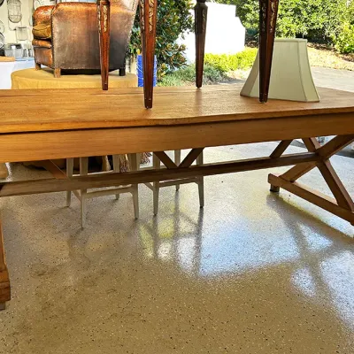 Sale Photo Thumbnail #266: Rustic natural wood trestle dining table featuring an X-base frame and long rectangular top.