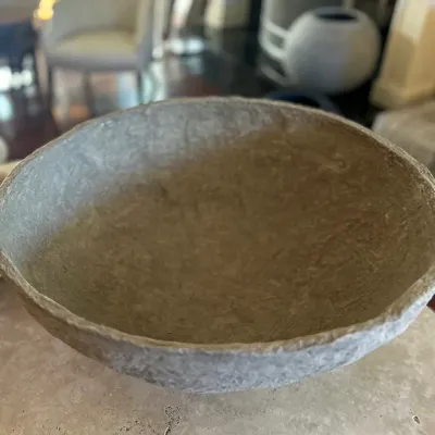 Sale Photo Thumbnail #40: Rustic papier-mâché or stone-effect decorative bowl with an organic, textured rim and neutral finish.