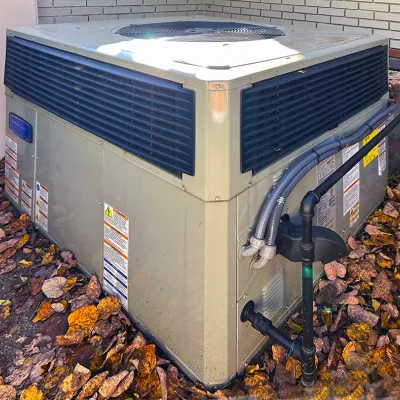Sale Photo Thumbnail #223: American Standard outdoor central air conditioning unit, installed outside next to a brick house wall.