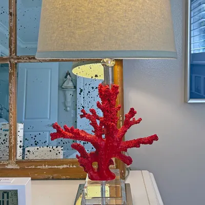 Sale Photo Thumbnail #24: Coastal-style table lamp featuring a bright red faux coral base on a stacked acrylic and polished chrome pedestal, topped with a beige drum shade.