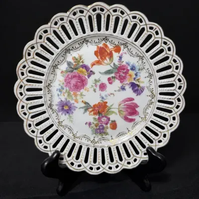 Sale Photo Thumbnail #67: German Dresden-style reticulated porcelain cabinet plate, featuring a hand-painted floral bouquet center and gilt-trimmed pierced lattice rim.