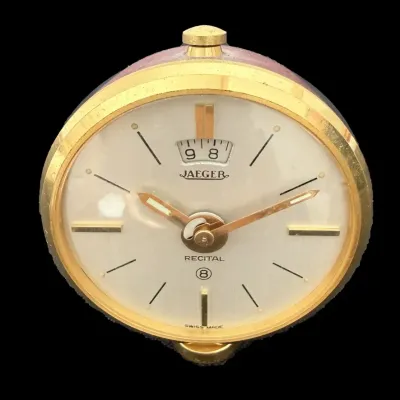 Sale Photo Thumbnail #61: Vintage Jaeger Recital 8-day brass pocket or travel clock featuring a cream dial with gold-tone accents.