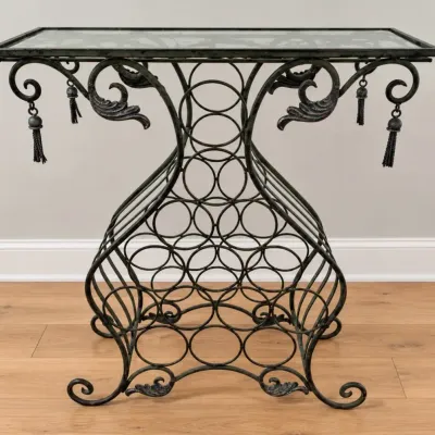Sale Photo Thumbnail #24: Wrought iron console table featuring an integrated wine rack base, glass top, scrollwork accents, and decorative hanging metal tassels.