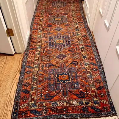 Sale Photo Thumbnail #11: Hand-knotted Heriz-style runner rug with traditional geometric motifs in terracotta, navy, and cream tones, featuring fringe ends.