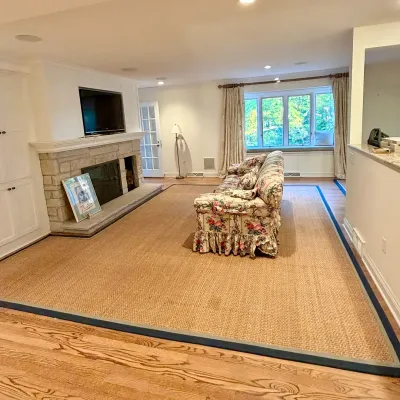 Sale Photo Thumbnail #10: Large natural fiber area rug with a blue cloth border, paired with a vintage floral patterned skirted sofa in a living room setting.