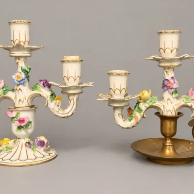 Sale Photo Thumbnail #35: Pair of Dresden-style porcelain three-light candelabras, featuring applied floral decorations, gilt accents, and one brass chamberstick insert base.