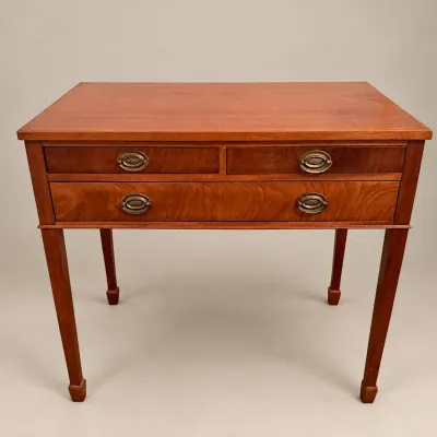 Sale Photo Thumbnail #21: Traditional cherry writing desk featuring three drawers with brass oval bale pulls and square tapered legs.