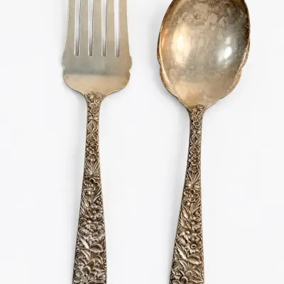 Sale Photo Thumbnail #38: Pair of S. Kirk & Son Sterling Silver salad servers featuring ornate repoussé floral relief handles.