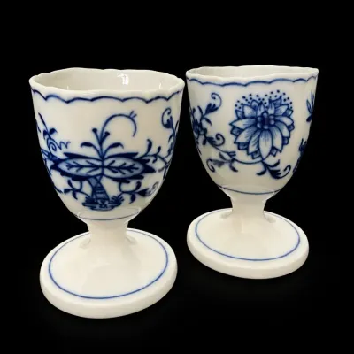 Sale Photo Thumbnail #62: Pair of Meissen-style blue onion pattern porcelain egg cups with scalloped rims and pedestal bases.