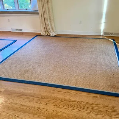 Sale Photo Thumbnail #68: Large woven natural sisal or jute area rug featuring a wide blue fabric border layout on hardwood floor.