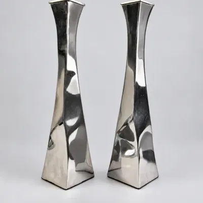Sale Photo Thumbnail #39: Pair of modern polished metal tapered candlesticks featuring a sleek, twisted geometric silhouette.