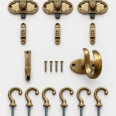 Sale Photo Thumbnail #55: Collection of antique brass hardware, including decorative turn latches, strikes, a wall hook, and a set of twisted screw-in utility hooks.