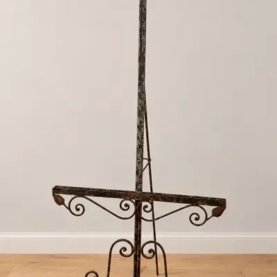 Sale Photo Thumbnail #59: Vintage wrought iron display easel featuring ornate scrollwork, leaf accents, and a finial top with an aged patina finish.