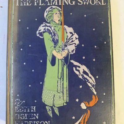Sale Photo Thumbnail #80: Antique hardcover book titled "The Flaming Sword" by Edith Ogden Harrison, featuring an illustrated Art Nouveau cloth cover.