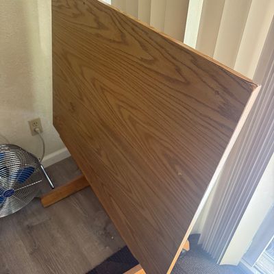 Sale Photo Thumbnail #296: Vintage adjustable wooden drafting table with a natural oak finish tabletop.