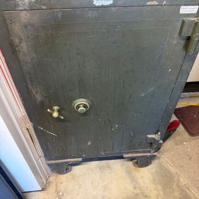 Sale Photo Thumbnail #298: Vintage heavy-duty industrial safe on casters with a green painted finish, combination dial, and T-handle.
