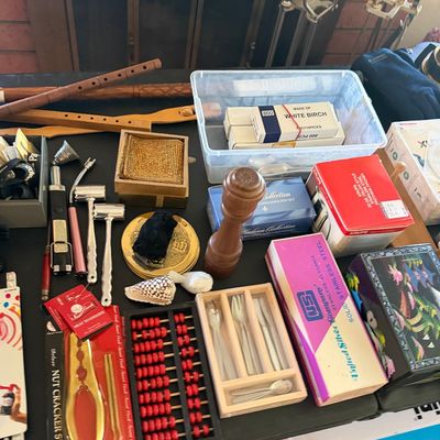 Sale Photo Thumbnail #138: Assortment of household collectibles and kitchen items, including wooden flutes, a miniature abacus, a nutcracker set, silver flatware boxes, and a wooden pepper grinder.